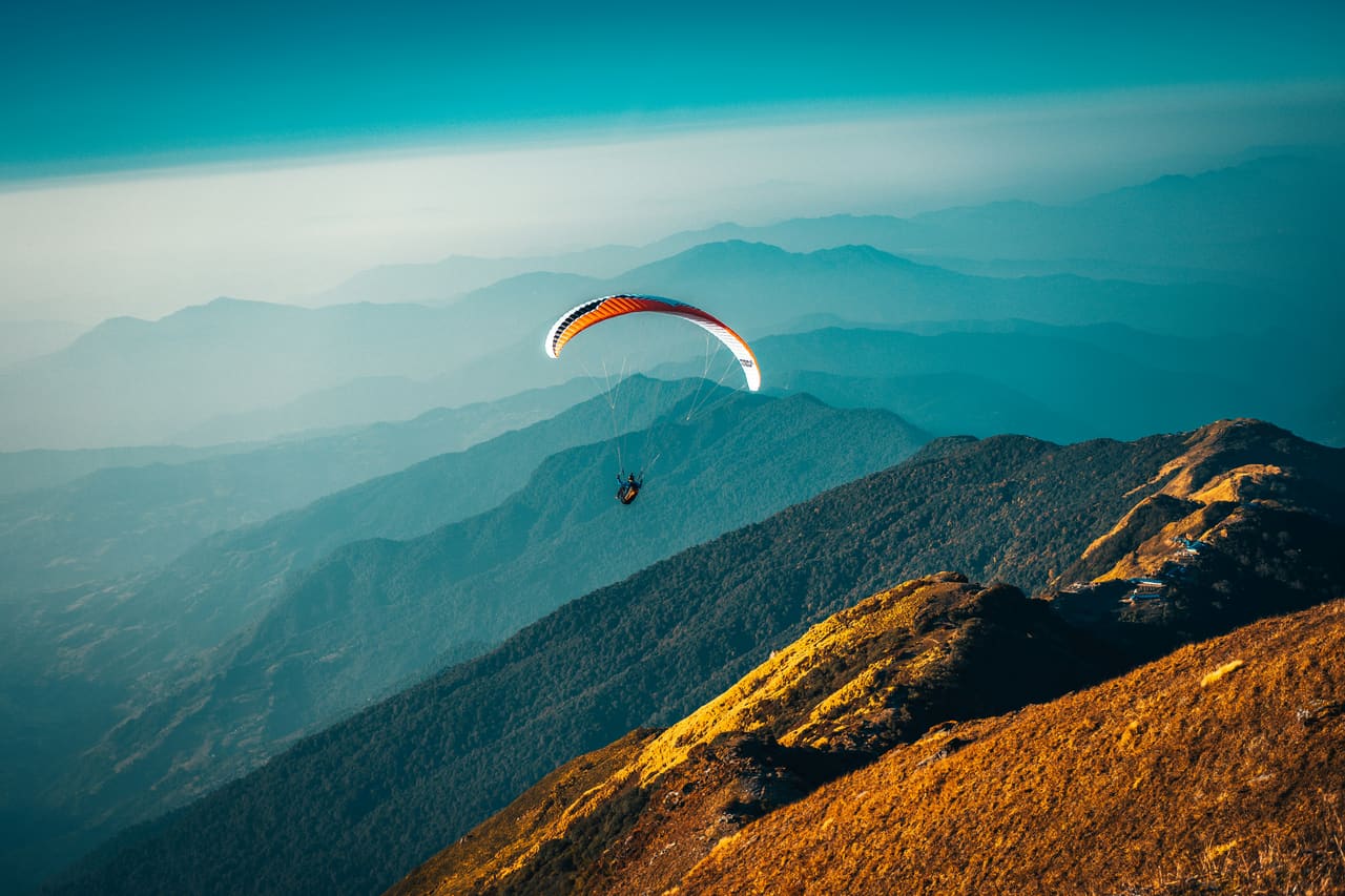 Paraglider above mountains